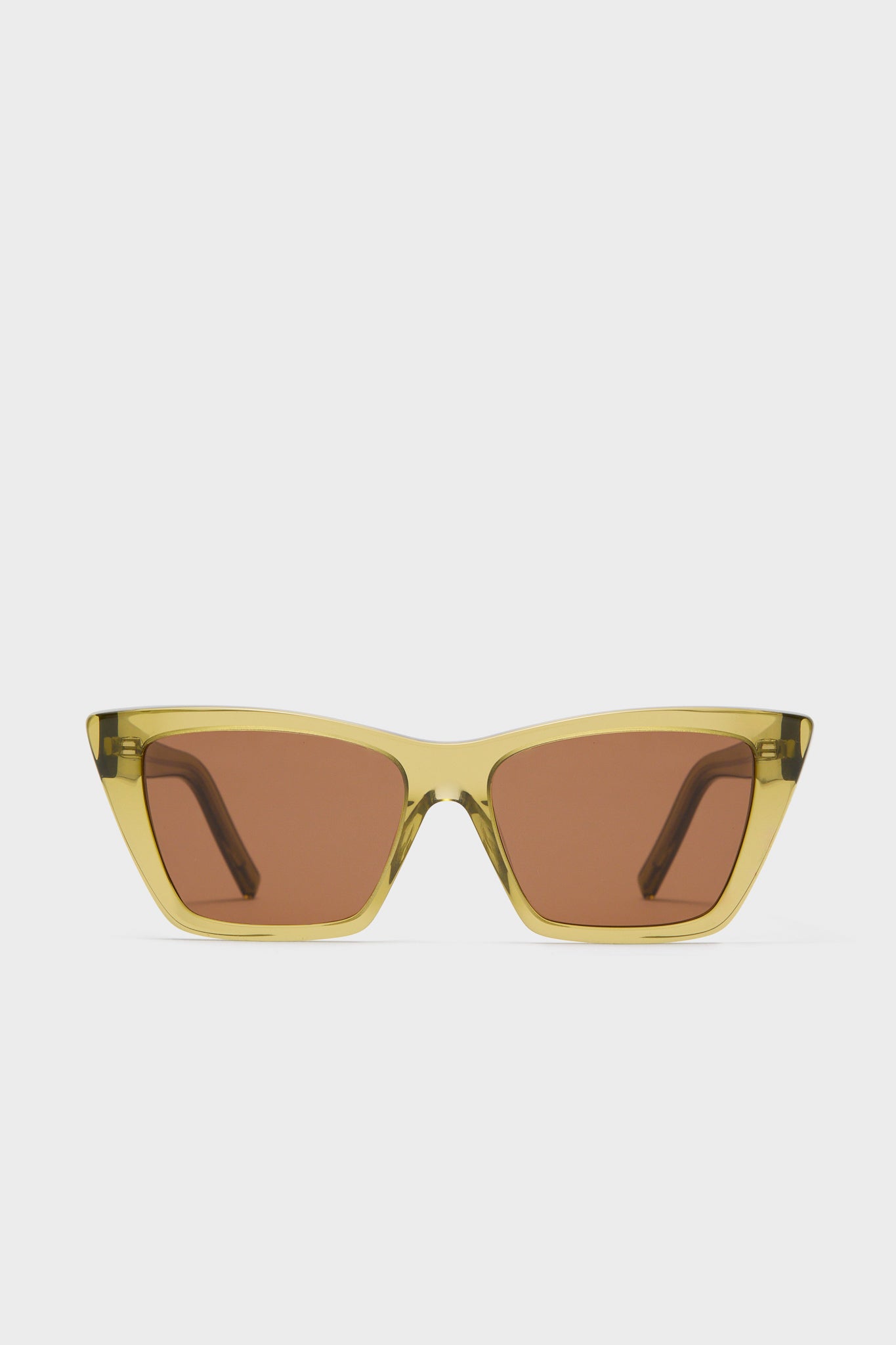 A pair of Saint Laurent Mica Sunglasses with translucent yellow cat-eye frames and brown tinted lenses, elegantly displayed.