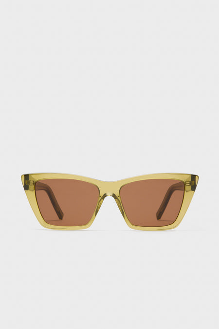 A pair of Saint Laurent Mica Sunglasses with translucent yellow cat-eye frames and brown tinted lenses, elegantly displayed.