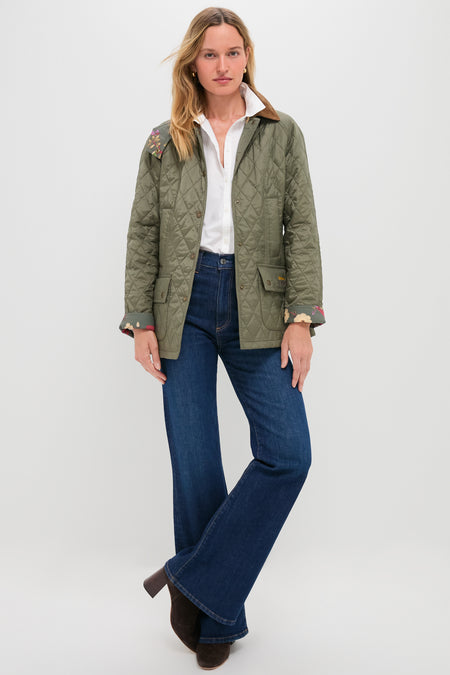 Woman wearing Zoe Gigi High Rise Skinny Flare jeans, styled with a quilted jacket and ankle boots, embodying an effortless, classic look for fun, high-end style.