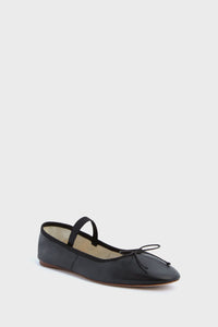 The Loeffler Randall Leonie Flat is a black leather ballet flat with a slim top strap, a delicate front bow, and a flat sole, shown against a plain white background.