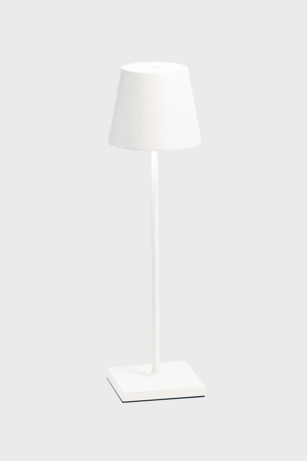 The Zafferano white LED table lamp features a matching shade, cordless illumination, a sleek design, and a rechargeable battery—ideal for any space.