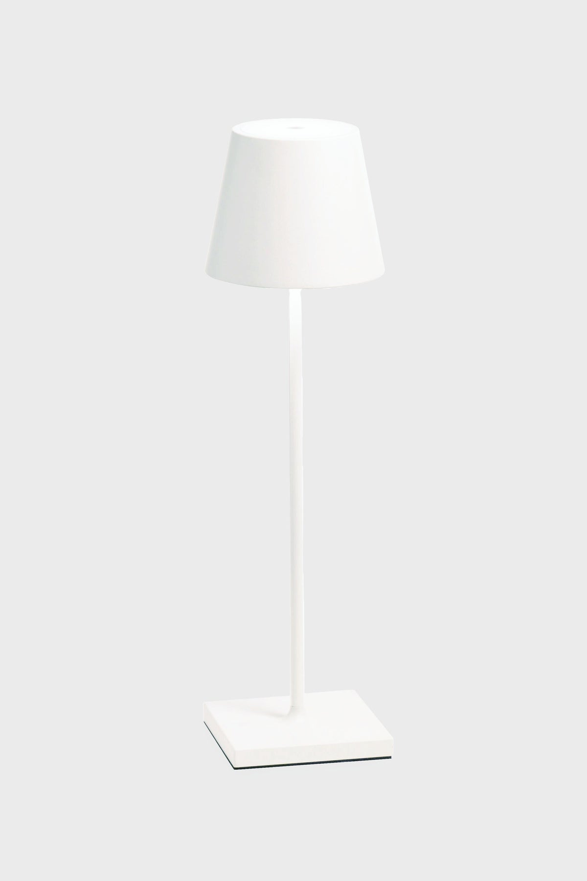 The Zafferano white LED table lamp features a matching shade, cordless illumination, a sleek design, and a rechargeable battery—ideal for any space.