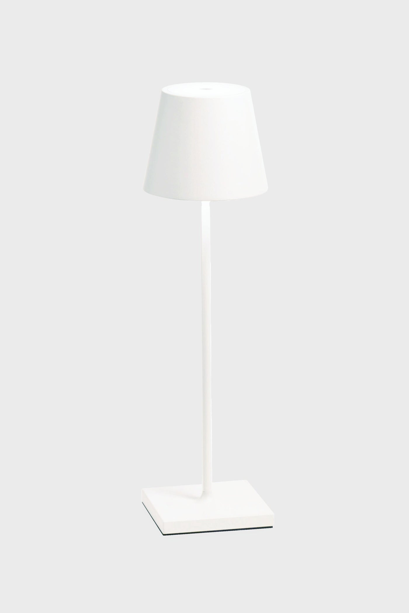 The Zafferano white LED table lamp features a matching shade, cordless illumination, a sleek design, and a rechargeable battery—ideal for any space.