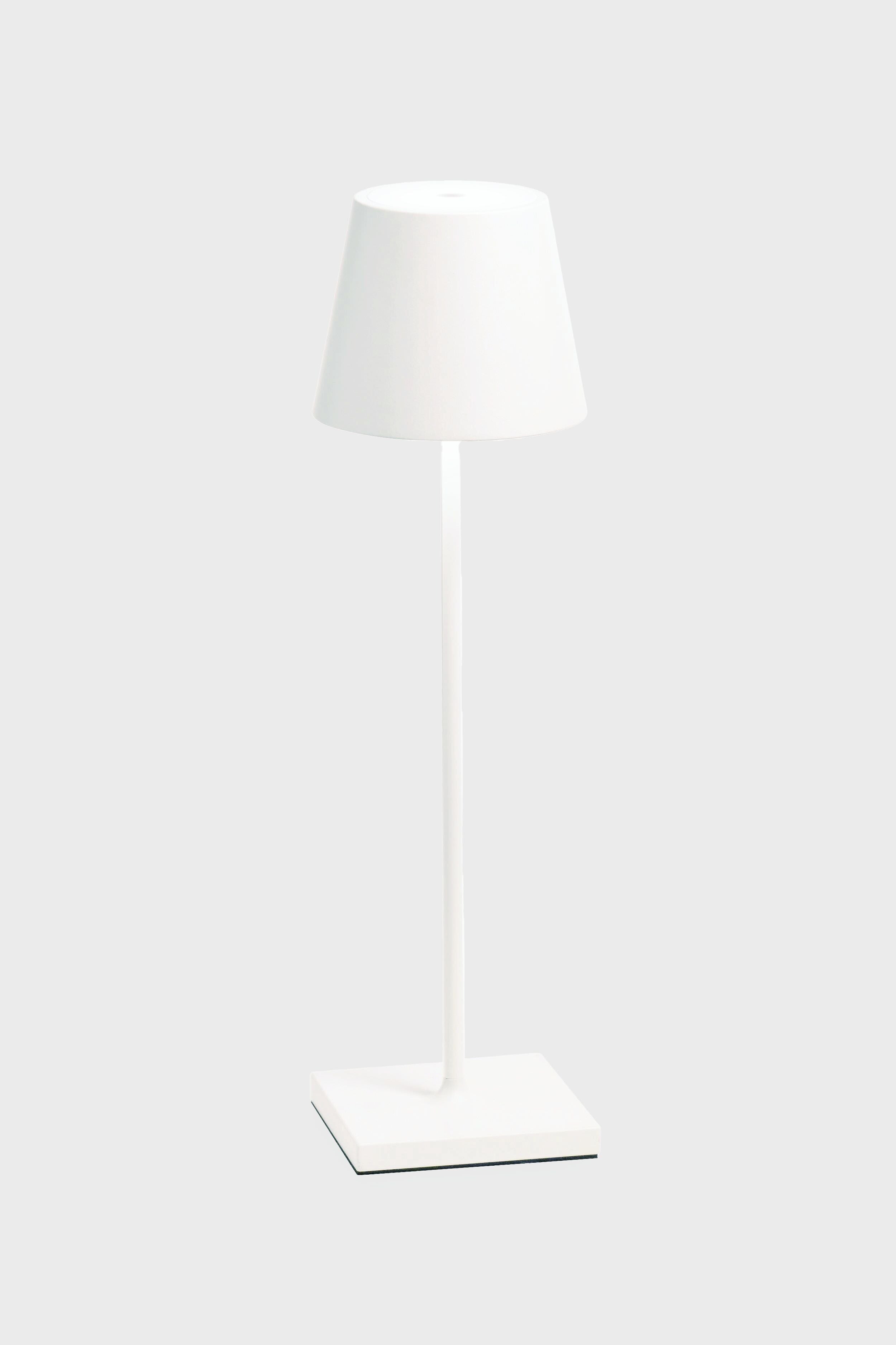 The Zafferano white LED table lamp features a matching shade, cordless illumination, a sleek design, and a rechargeable battery—ideal for any space.