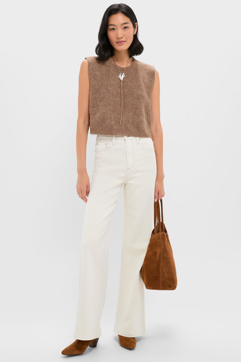 Woman models an effortless, classic look featuring the High Polish Silver Lydia Bolo Tie Necklace, complementing her casual outfit with a high-end, fun vibe.