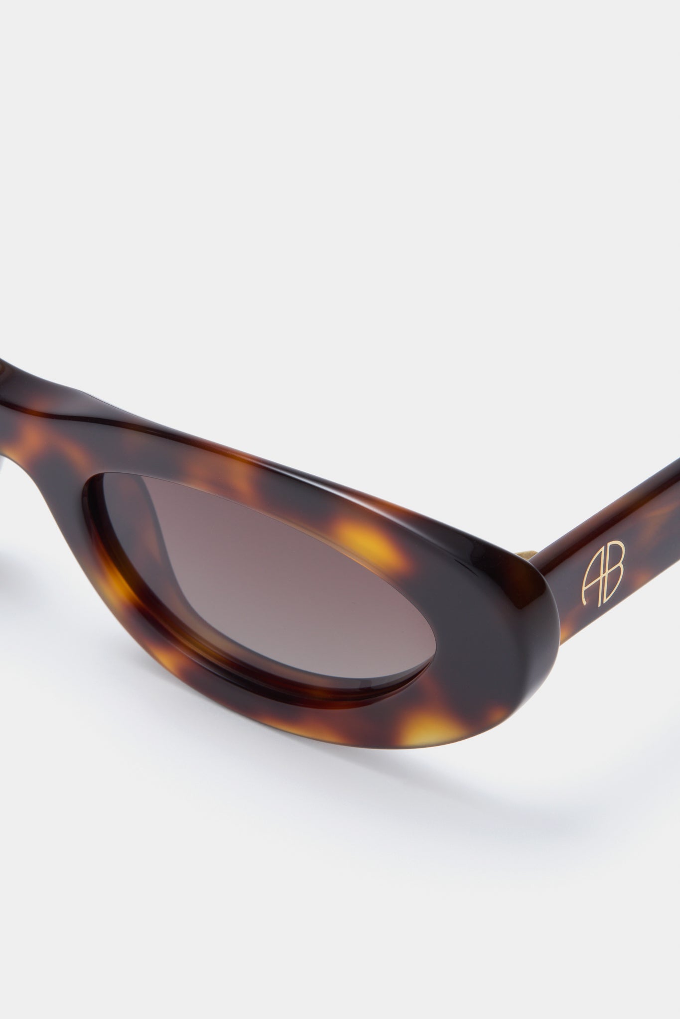Tortoise Roma Sunglasses: Classic tortoiseshell cat-eye frames with gold AB logo, featuring effortless style and high-end detailing for a fun, confident look.