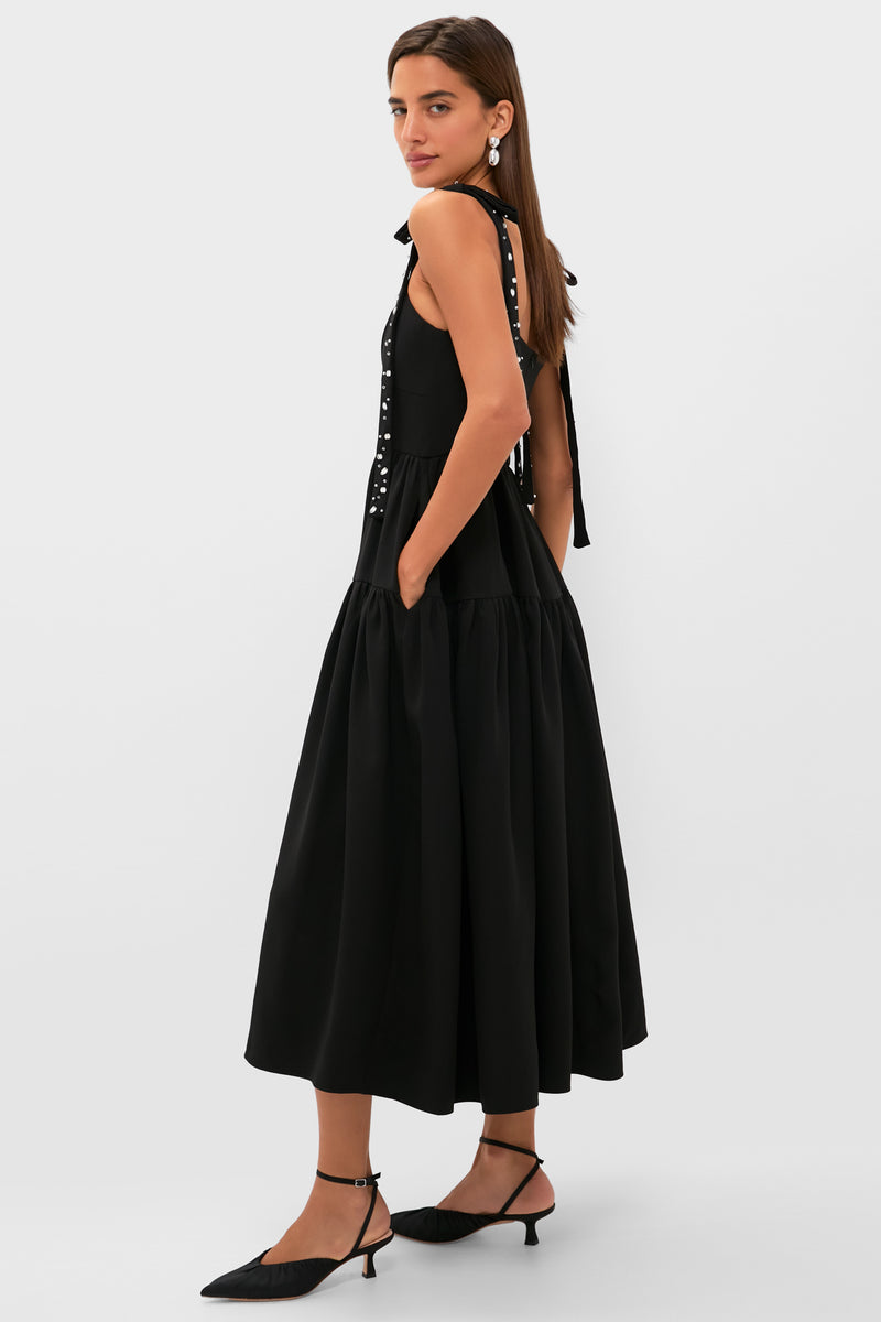 Black Embellished Agnes Maxi Dress features classic elegance with tied shoulder bows, corset waist, and side pockets. Effortlessly fun and high-end, perfect for special occasions.