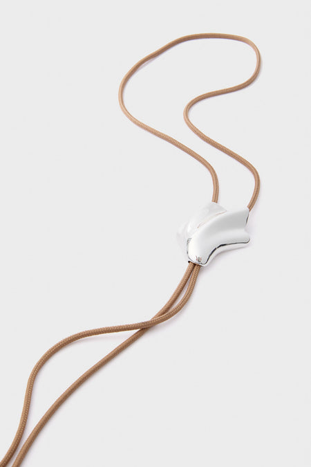 High Polish Silver Lydia Bolo Tie Necklace with adjustable silver slider on a light tan cord; a classic, effortless accessory for fun, high-end styling.