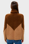 Back view of a woman in a classic Tan & Brown Diamond Demi Turtleneck, effortlessly styled with blue jeans, showcasing its ribbed, mid-weight knit and whipstitch details.