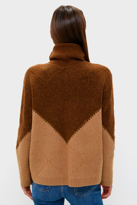Back view of a woman in a classic Tan & Brown Diamond Demi Turtleneck, effortlessly styled with blue jeans, showcasing its ribbed, mid-weight knit and whipstitch details.