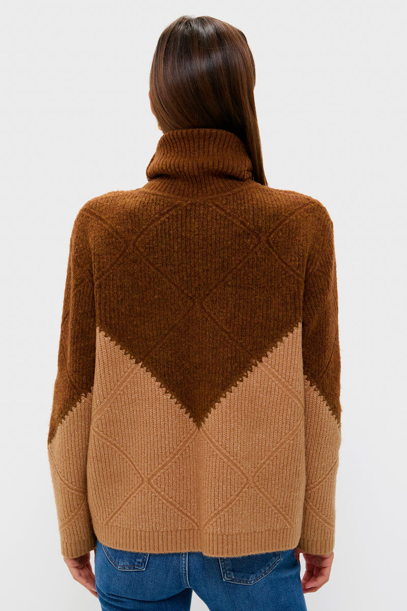 Back view of a woman in a classic Tan & Brown Diamond Demi Turtleneck, effortlessly styled with blue jeans, showcasing its ribbed, mid-weight knit and whipstitch details.