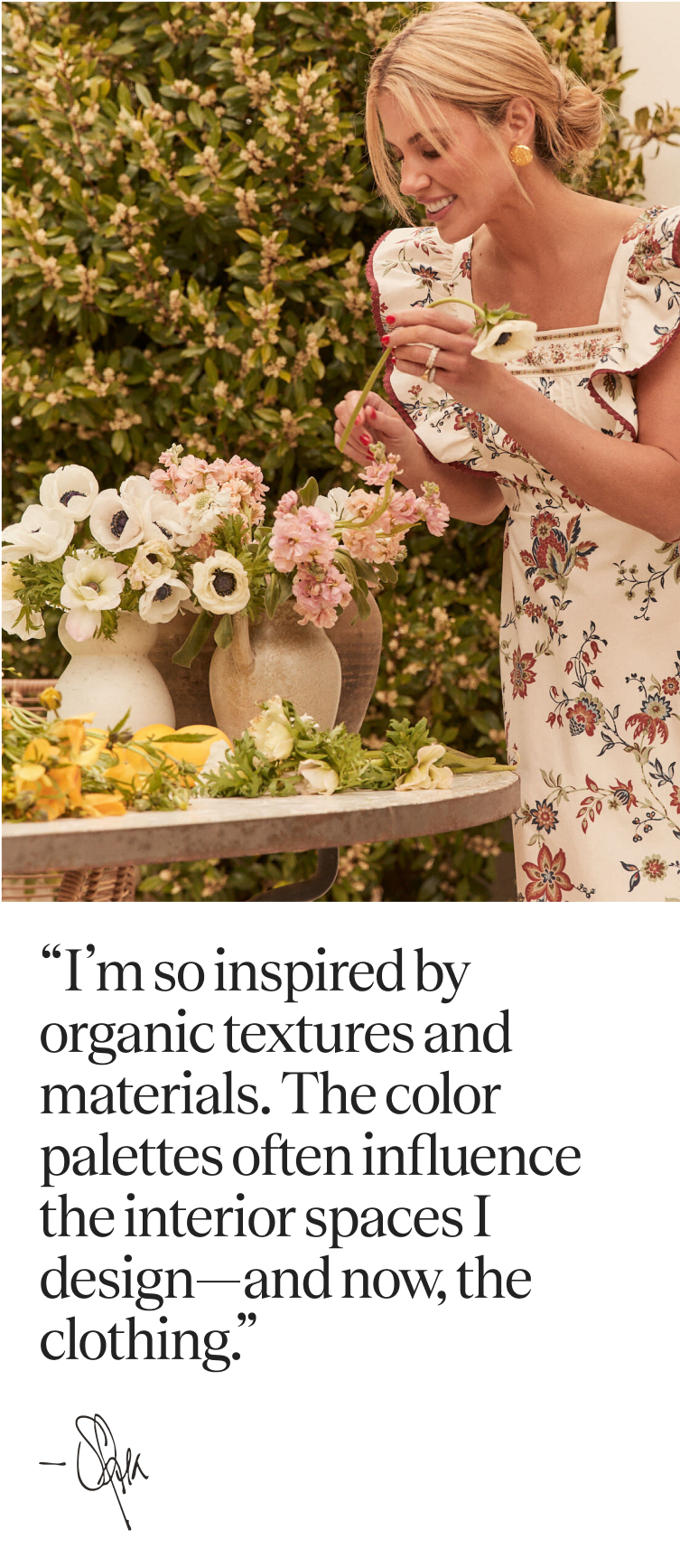 Shea McGee arranging flowers in a chintz patterned long dress with a square neckline and flutter sleeves 