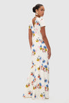 Retro Bouquet on White Fosette Gown: A classic, high-end maxi dress featuring effortless floral prints, back cut-out, and ruffled hem, styled with fun double-pearl earrings.