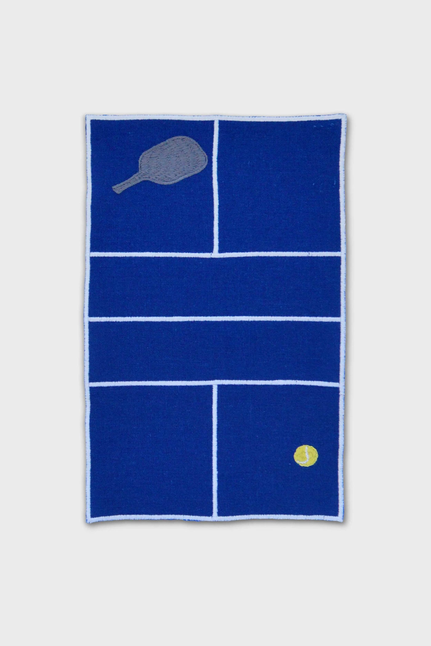 A blue rectangular Chefanie mat with white pickleball court lines, a racket in the top left, and yellow ball in the bottom right—ideal for displaying pickleball gifts or as playful Chefanie cocktail napkins.