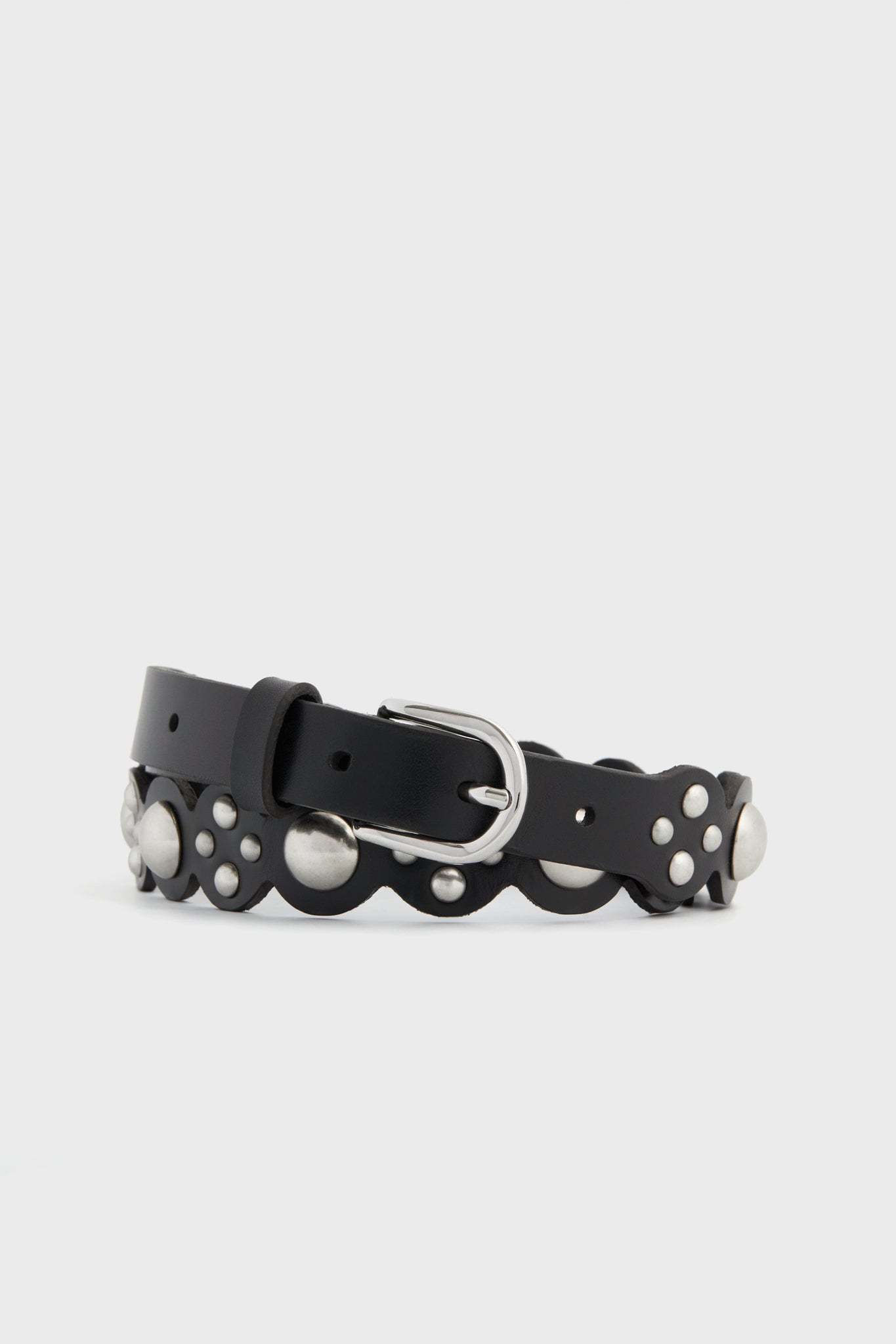 The Isabel Marant black calfskin leather belt features scalloped edges, silver studs, and a silver buckle—an iconic accessory from the brand.