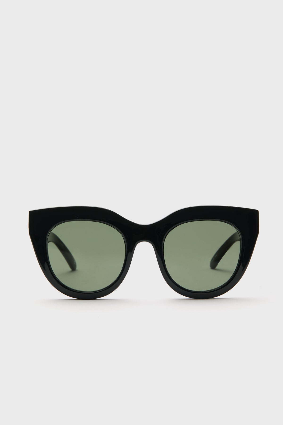 A pair of Le Specs cat eye sunglasses in black with dark tinted lenses is displayed.