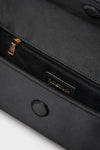 Close-up of Black Satin Gabrielle Clutch interior, showcasing a classic zippered pocket with gold hardware and a small suede-lined pocket, embodying effortless high-end style.