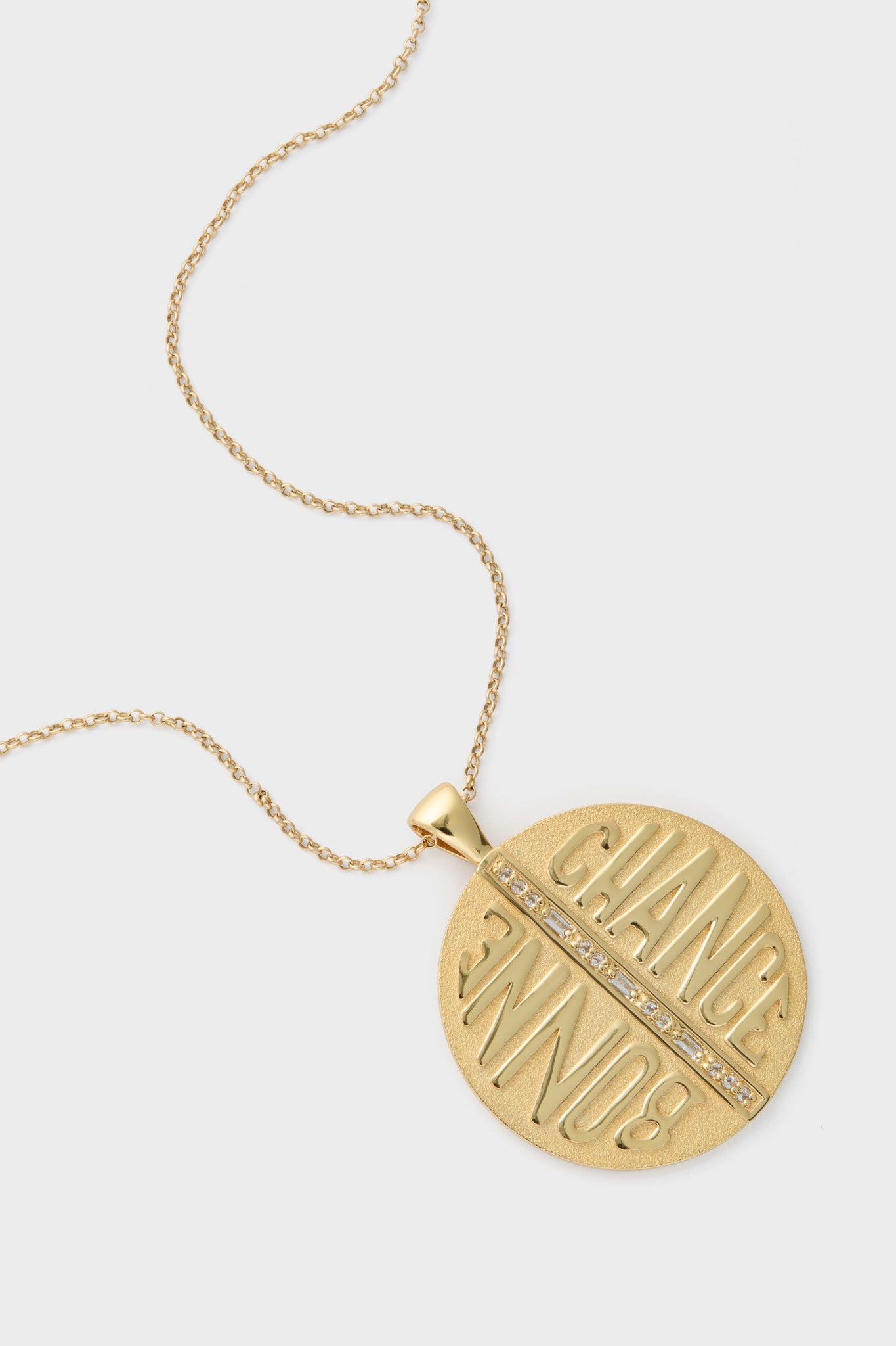 Gold Jumbo Bonne Chance Coin Necklace: Classic gold-tone pendant with BONNE CHANCE and sparkling stones, offering effortless, high-end style and fun, positive vibes for any occasion.