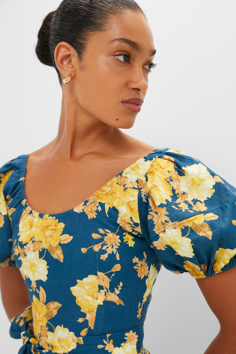 Nora Floral Navy Leiria Midi Dress features a classic scoop neckline, effortless puff sleeves, and high-end floral design. Ideal for fun occasions, exuding elegance and confidence.
