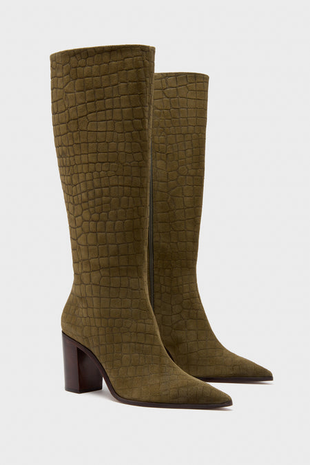 A pair of Schutz knee-high, olive green boots featuring a crocodile-textured pattern, high block heels, and a chic modern design.
