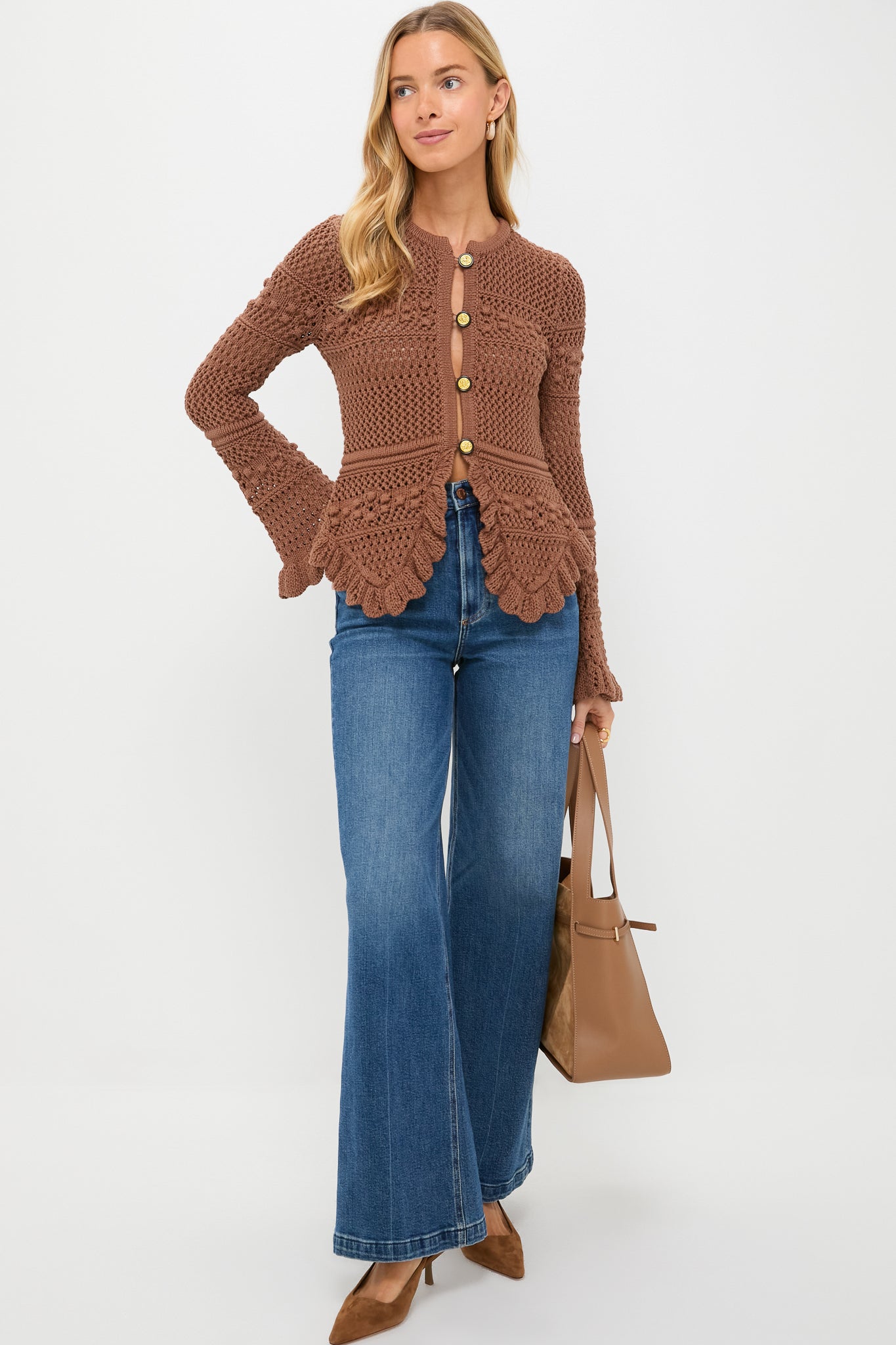 Woman models an outfit styled with the Camel Cleo Suede Tote, a high-end, classic accessory, showcasing effortless elegance and fun with its sculptural, sophisticated design.