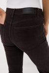 Rear view of Mocha Kinsley Mid Rise Ultra Flare Cord pants by PISTOLA, showcasing classic, effortless design with back pockets and luxurious leather patch detail.