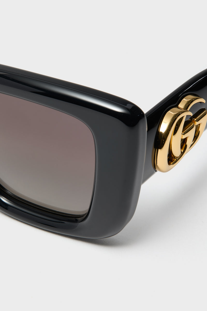 Shiny Black Square GG Bag Sunglasses feature classic black acetate frames, gradient lenses, and a gold Gucci logo on the temples for an effortless, high-end look.