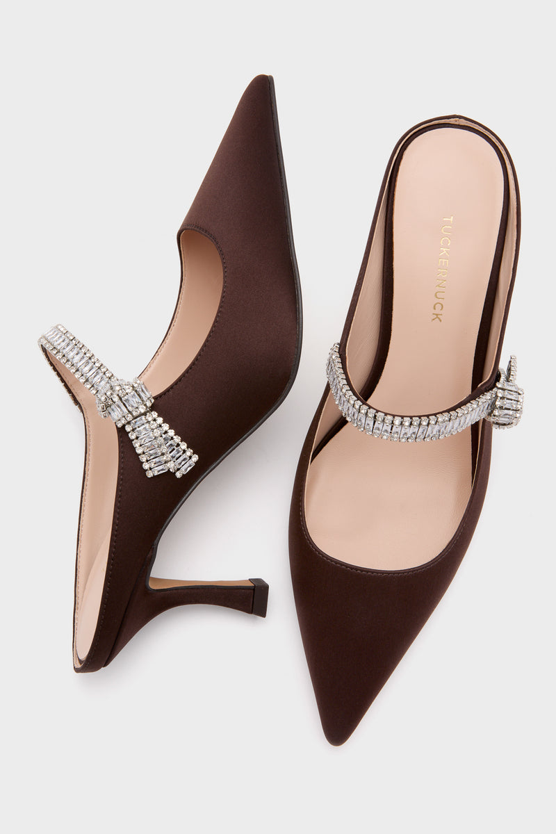 Chocolate Satin Mae Heels: classic mule-style with pointed toes and crystal bow accents, offering effortless elegance and fun for high-end occasions.