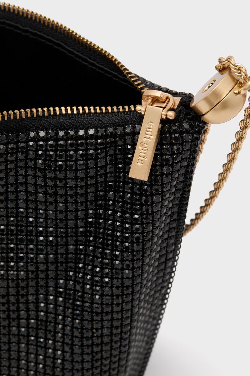 Cult Gaia Black Rue Wristlet, adorned with black beads and gold detailing, exudes classic elegance and effortless glamour, perfect for high-end evening events.