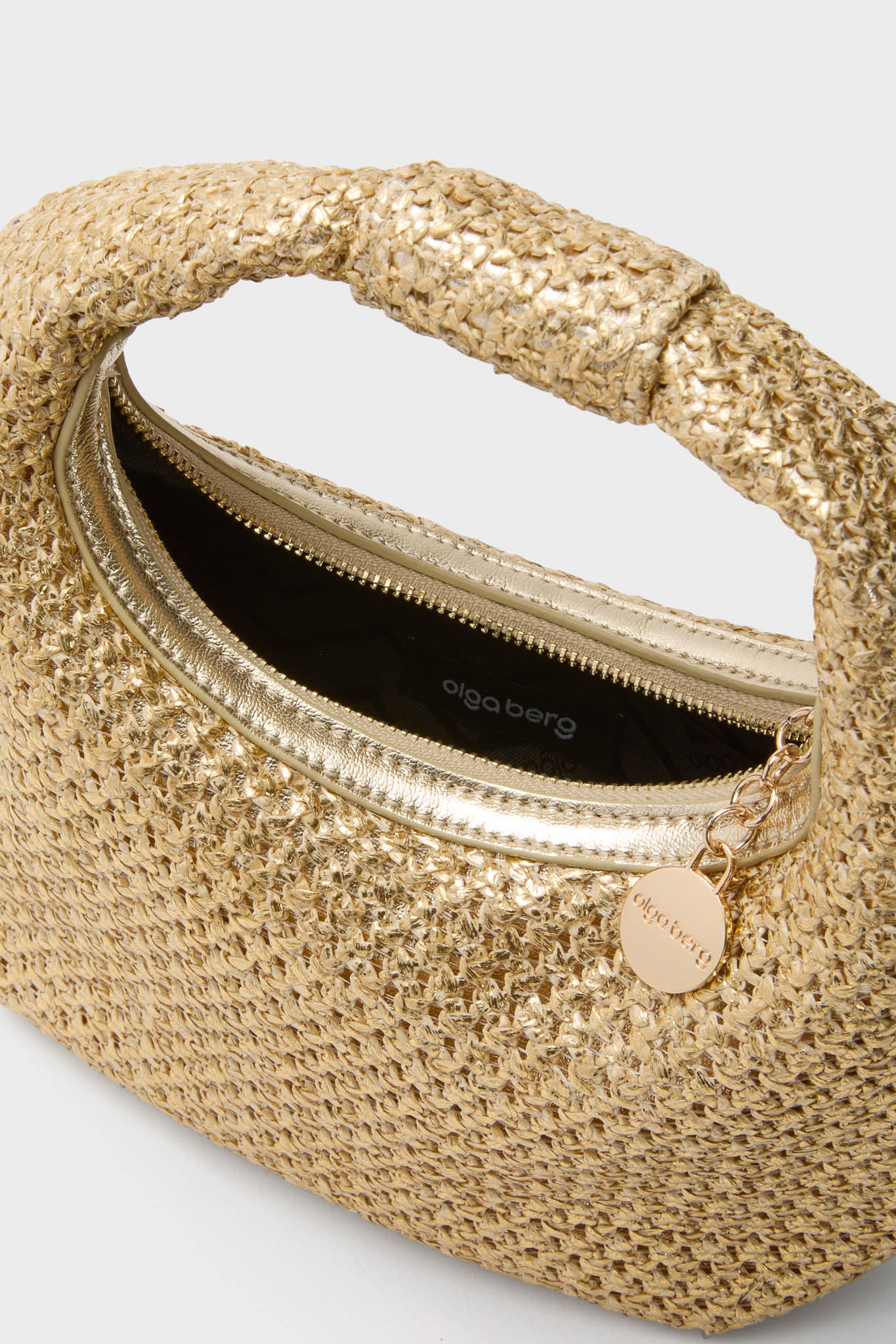 Gold Eden Woven Hobo, a classic and effortless metallic gold handbag with a top handle, zip closure, and Olga Berg branding, perfect for high-end, fun occasions.