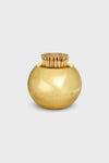 AERIN’s round, shiny gold container, crafted from solid brass as a match striker, holds upright wooden toothpicks—an elegant piece perfect for artisanal home decor.