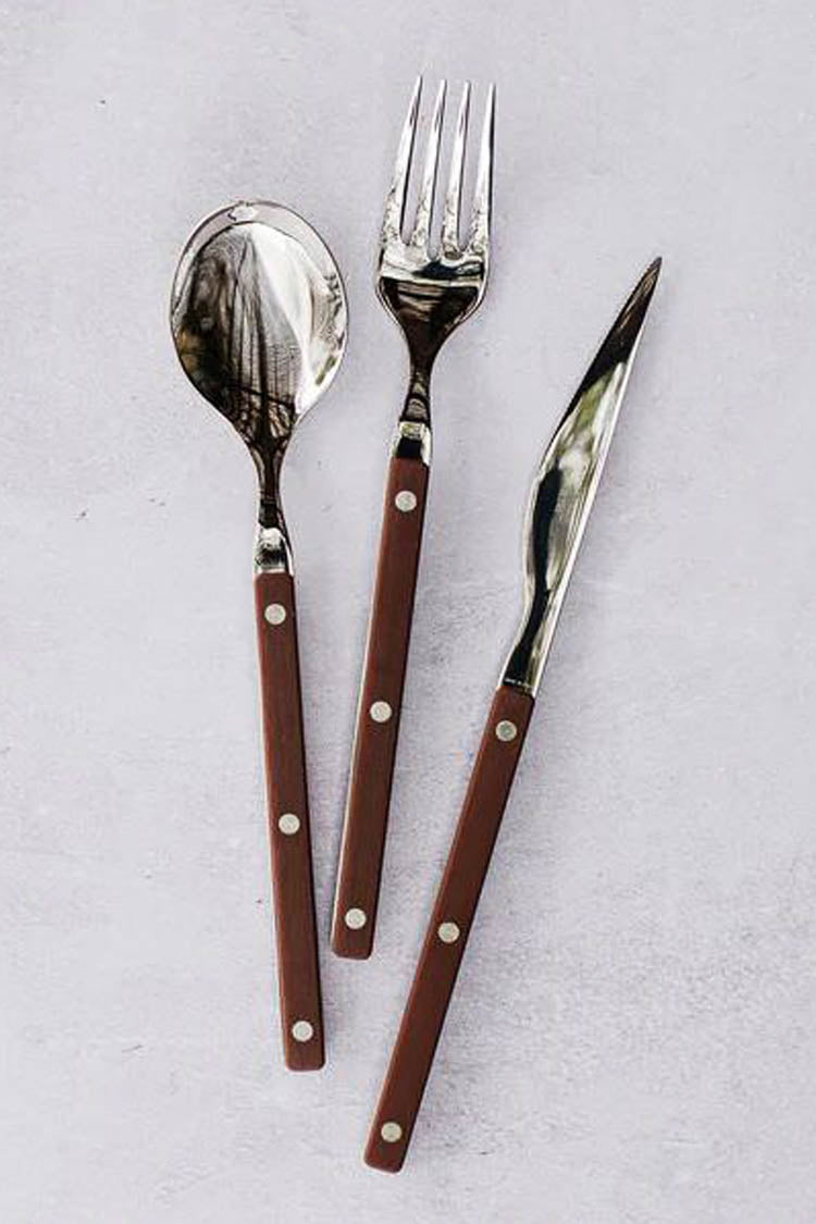 Pastello Brown Three-Piece Place Setting featuring a spoon, fork, and knife with durable stainless steel heads and classic brown riveted handles, embodying effortless, fun, high-end dining style.