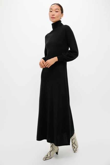 Classic Black Cashmere Turtleneck Maxi Dress with blouson sleeves and A-line silhouette, styled effortlessly with light snakeskin ankle boots, embodying a high-end, fun, and versatile look.