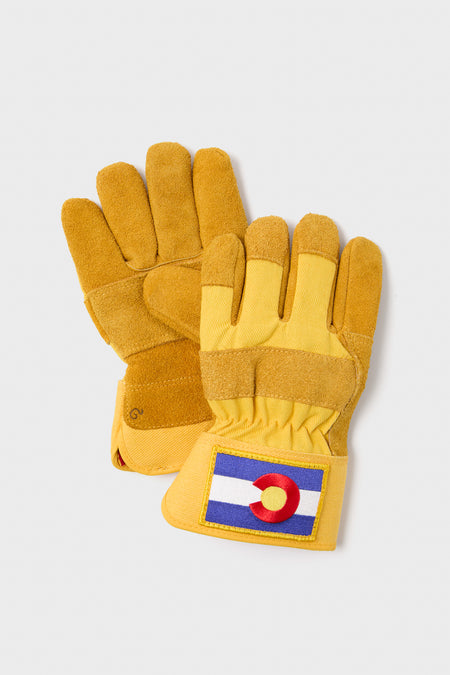 Brisket Supply’s yellow insulated work gloves feature suede palms, cuffs, and a Colorado state flag patch on each cuff.