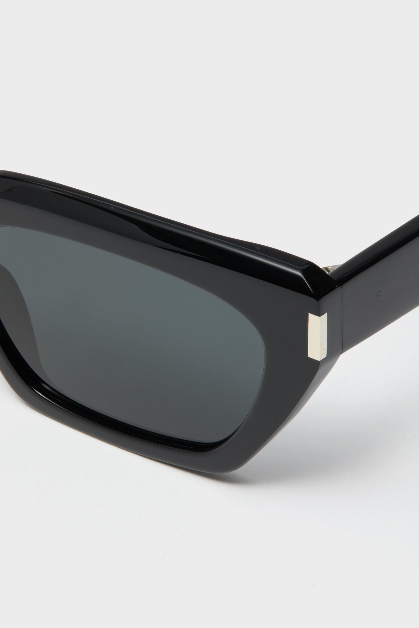 Shiny Solid Black Corner Angle M Sunglasses with a chunky cat-eye frame, silver hinge accents, and dark lenses, embodying a classic and effortless high-end style.