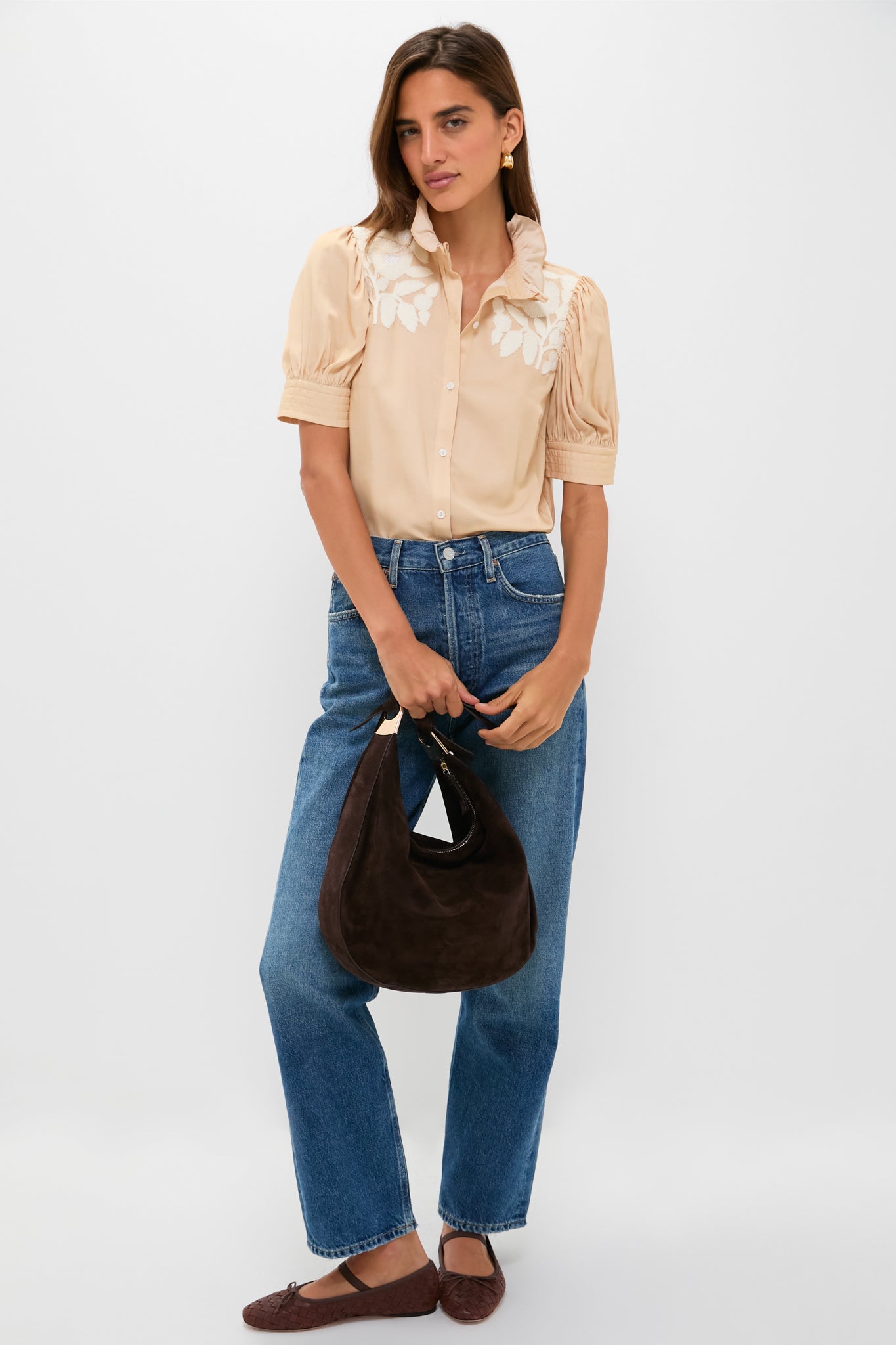 Effortlessly classic, the Tan & Cream Embroidery Louisa Blouse features ruffled collar, puff sleeves, and floral embroidery, paired with high-waisted jeans and woven ballet flats.