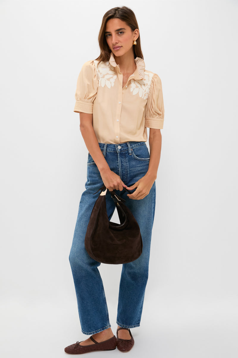 Effortlessly classic, the Tan & Cream Embroidery Louisa Blouse features ruffled collar, puff sleeves, and floral embroidery, paired with high-waisted jeans and woven ballet flats.
