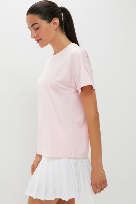 Woman models the classic and effortless Pink Short Sleeve Performance Jersey Ryan Boyfriend Tee, perfect for an active, high-end lifestyle.
