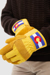 Classic Colorado Gloves in mustard-yellow, featuring Colorado flag patches, worn over a dark sweater. Effortless design with insulated, waterproof protection for high-end, fun cold-weather activities.