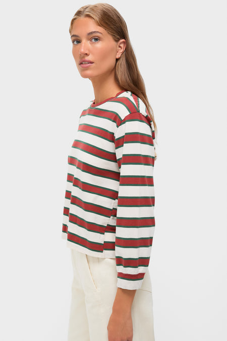 Fashion model in profile wearing the Cream with Brown Campus Crew tee with classic stripes, paired with cream trousers, embodying an effortless, high-end, and fun collegiate style.