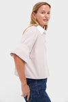 Woman models the high-end Spanish Villa and White Next Ex Shirt, featuring a classic, cropped boxy silhouette with a spread collar and effortless double roll cuffs.