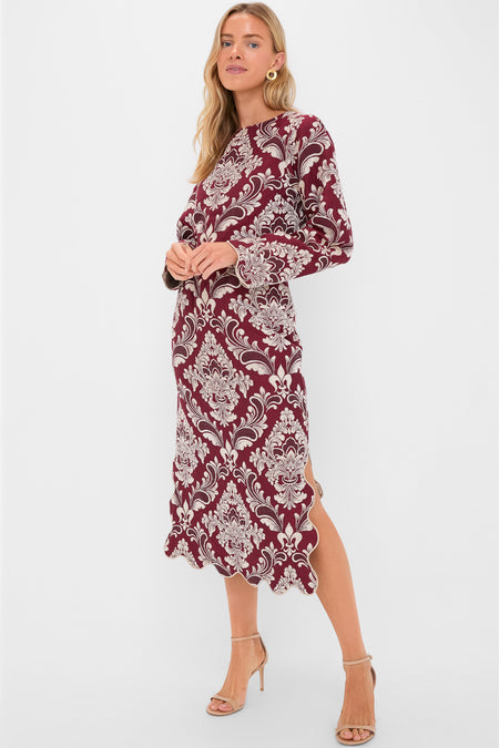 Woman models classic Blush Pink and Burgundy Bicolor Jacquard Waves Midi Skirt with floral pattern, scalloped hem, and side slit, creating an effortless, high-end look.