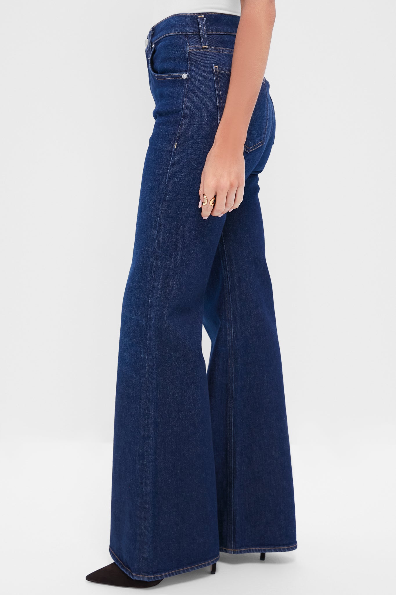 Madison Kimberly 70's Flare jeans, high-waisted with a dramatic bell-bottom, classic five-pocket design, worn effortlessly with black heels and sculptural gold rings.