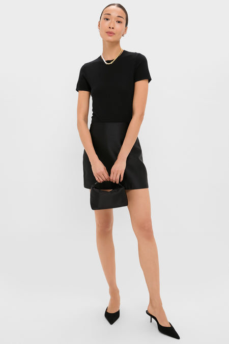 Woman showcasing the classic Two-Tone Sofia Choker, an effortless, high-end piece worn as a necklace, enhancing her chic black outfit with a touch of fun elegance.