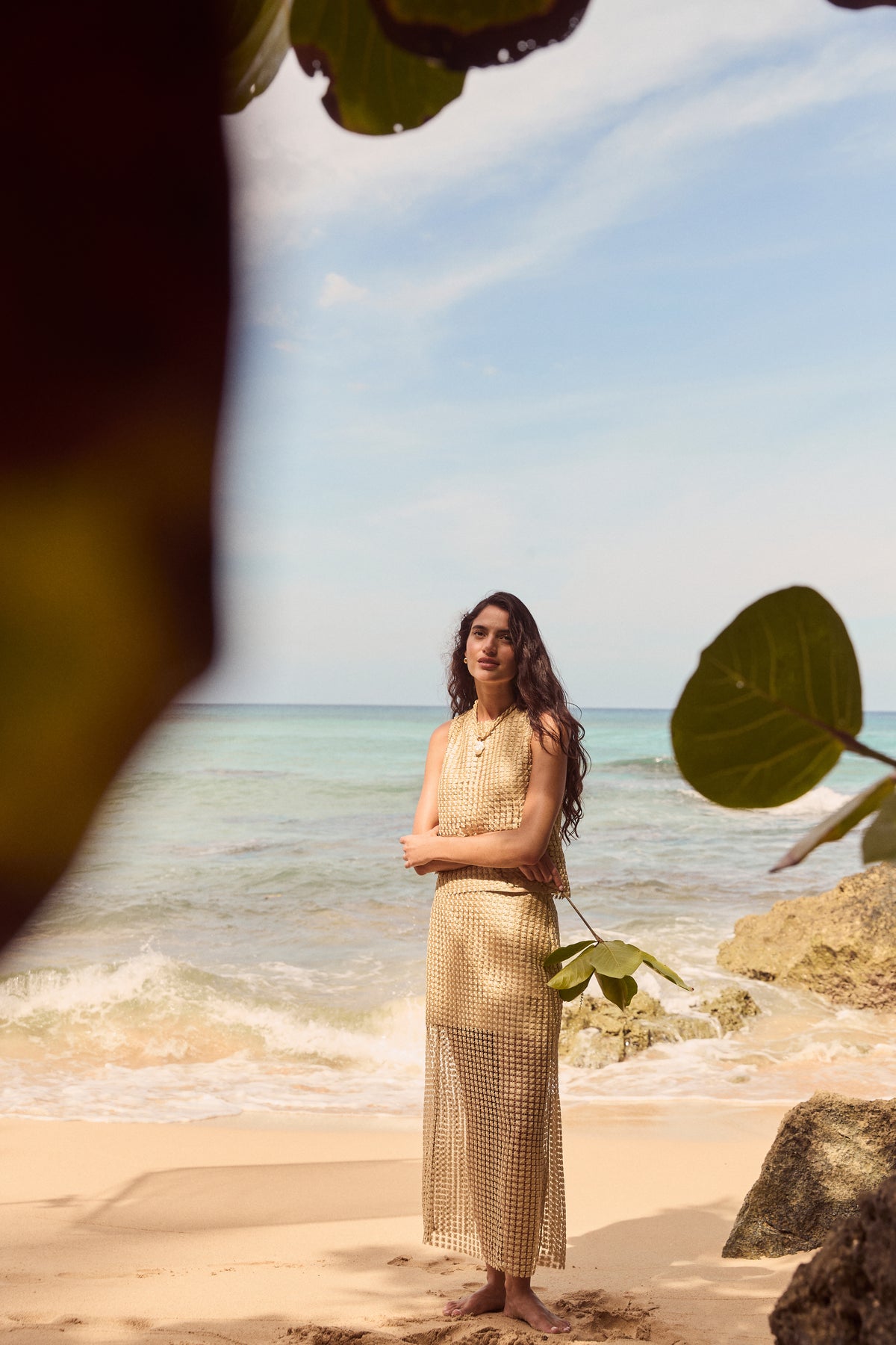 Young woman in a gold metallic star lace Eve skirt, exuding effortless glam at the beach, embodying Tuckernuck's fun, classic, and high-end style.