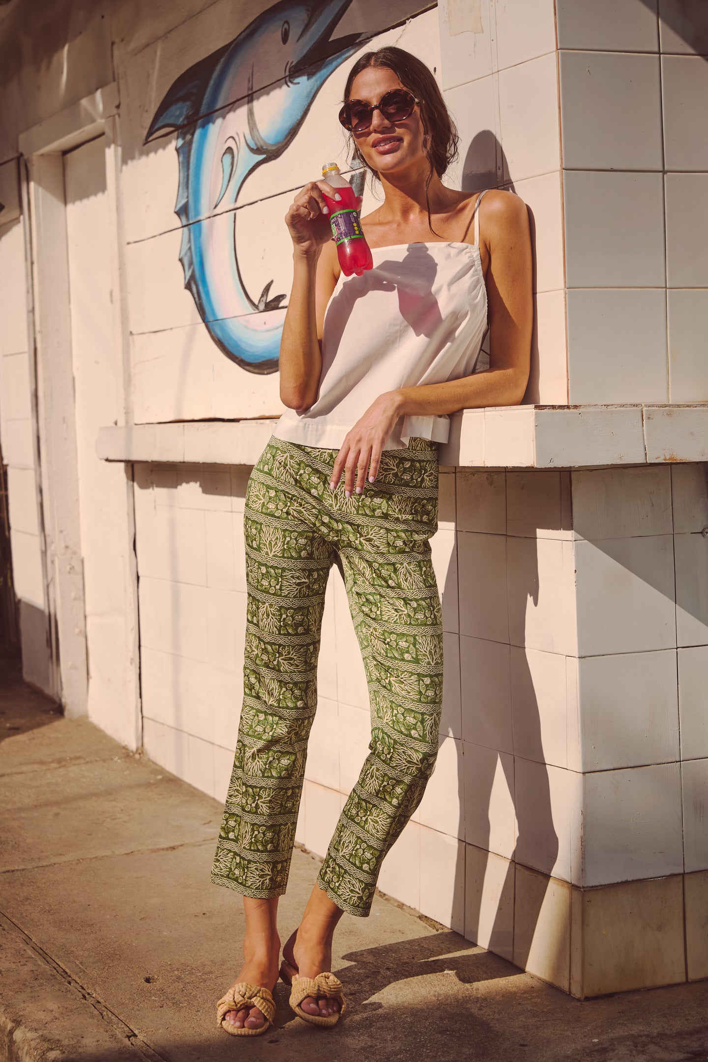 Young woman wearing Venezia Eliza Sunglasses with bubble frames, exuding effortless and high-end style in a sunlit setting, embodying a classic, fun, and confident vibe.