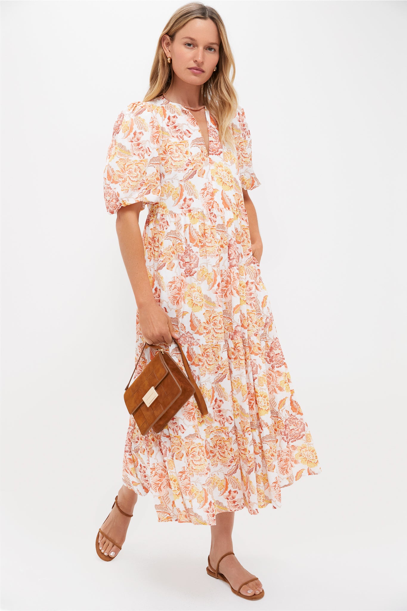 Model wearing an effortless white dress with orange-yellow floral print, accessorized with a classic, high-end Peach Moonstone Candy Necklace, enhancing a fun, confident style.