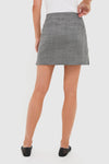 Heathered Grey Marta Mini Skirt with classic wrap button closure, effortlessly chic for work or play, styled with ballet flats for a fun, high-end look.