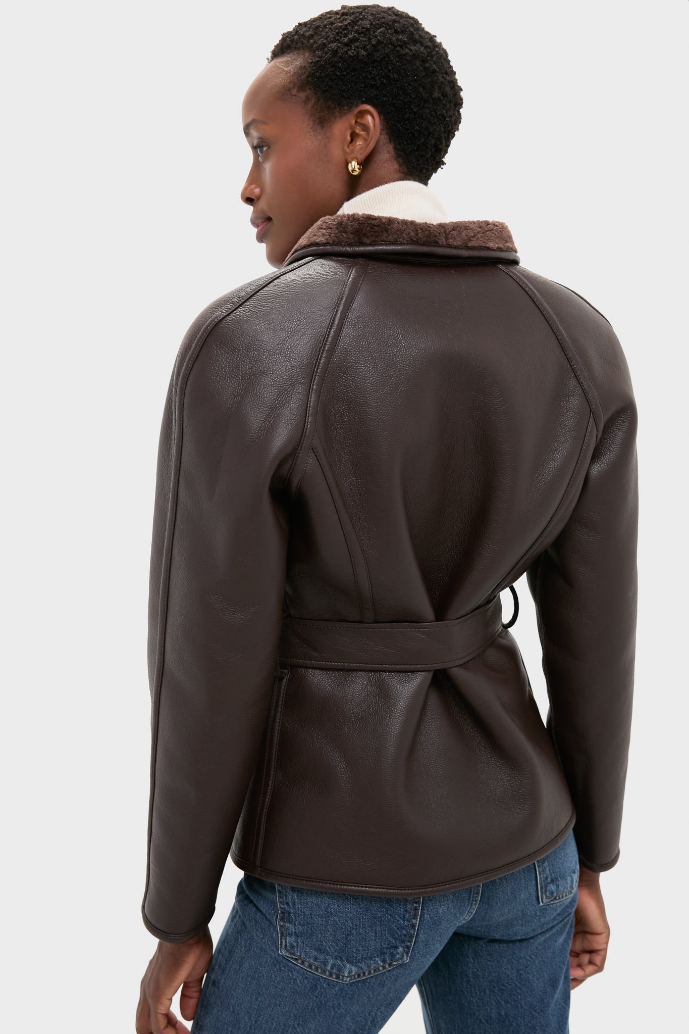 Effortlessly stylish, the Reversible Marron Fur Coat features a classic faux leather design with a plush collar and self-tie belt, epitomizing high-end sophistication.