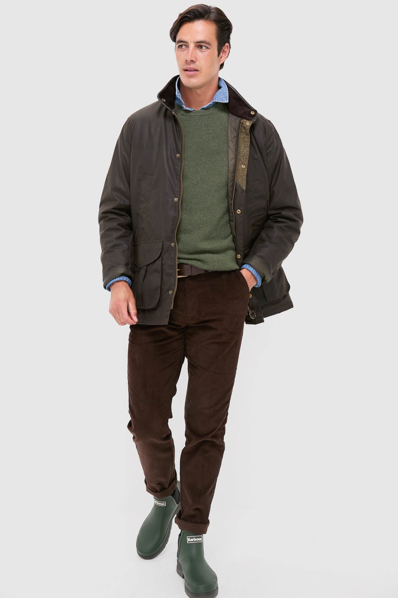 Man wearing an effortlessly classic outfit featuring Olive Nimbus Chelsea Welly Boots with Barbour branding, perfect for a high-end, fun, and casual wardrobe.